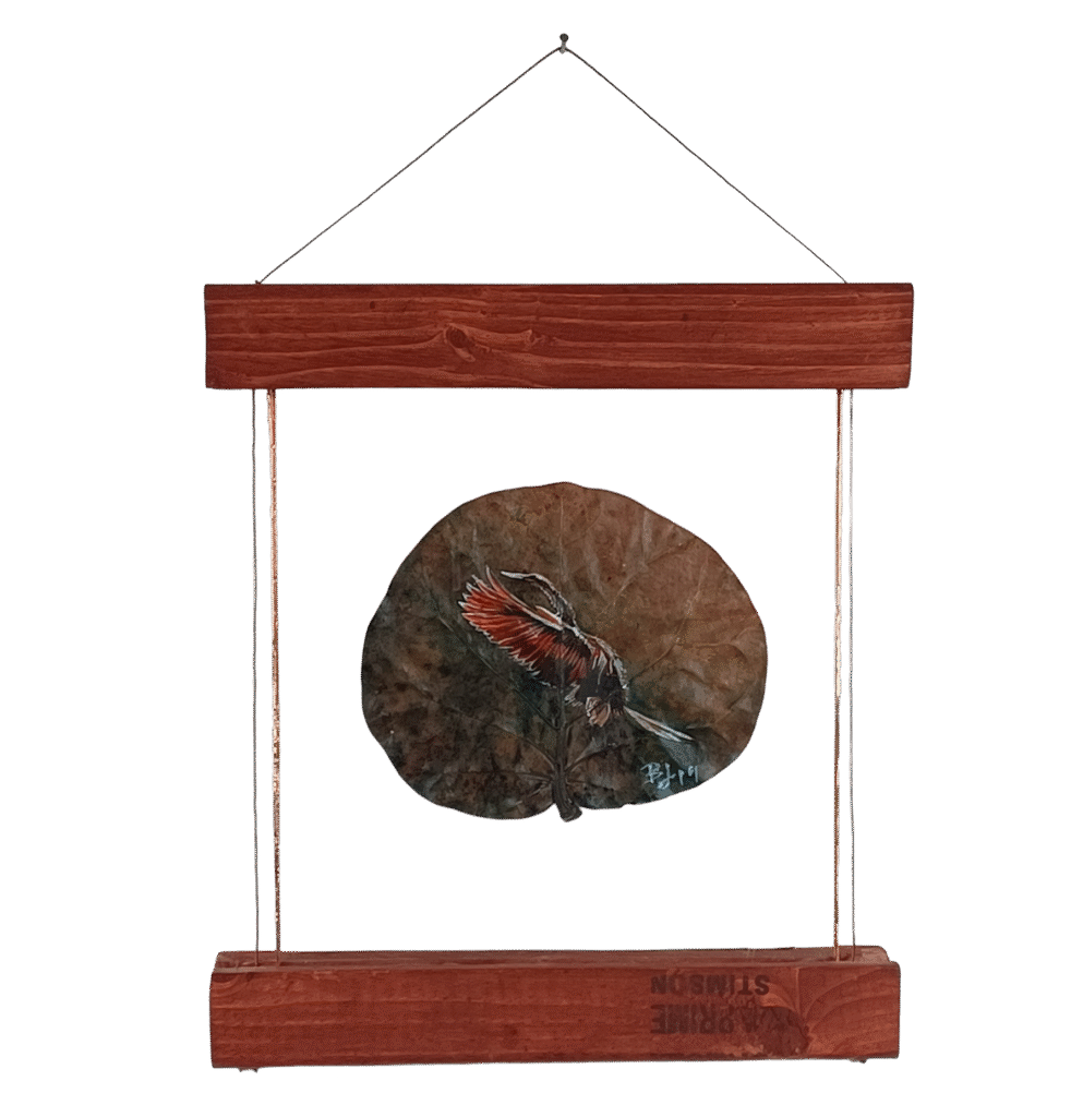 Painting of a flying cormorant bird on a dried sea grape leaf, mounted in a custom floating frame by the artist behind DavisonDesigns. This piece has been honored in juried online art shows.
