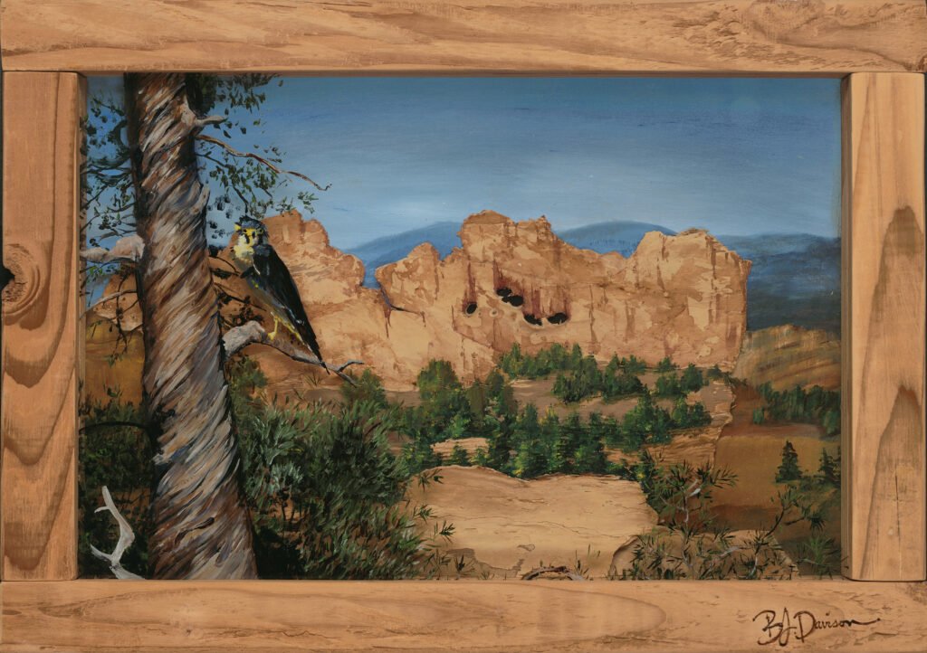 Garden of the Gods reimagined—cliffs sculpted from melaleuca bark, a hawk poised on glass, framed in handmade wood shadow-box frame. Nature layered in memory and motion.